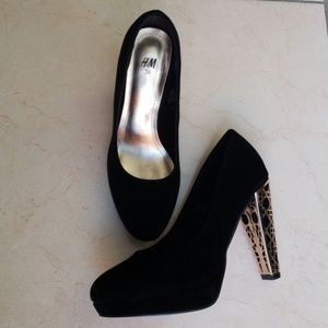 Black suede platforms with gold geo plated heel